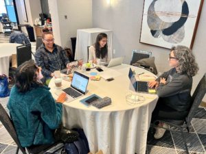 A writing group at the HPRS Winter Writing Retreat connects with each other while working on their writing projects.
